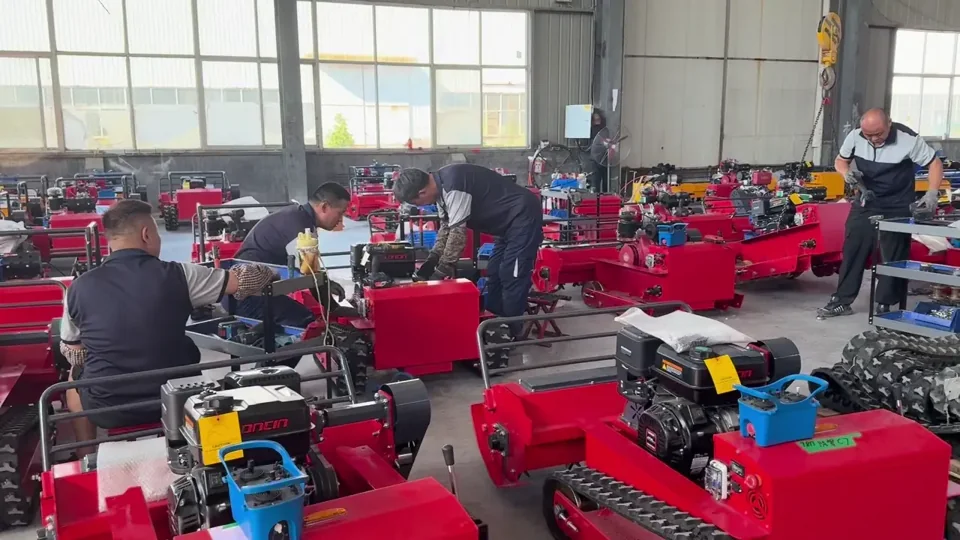 Workers assembling tracked machines in the workshop