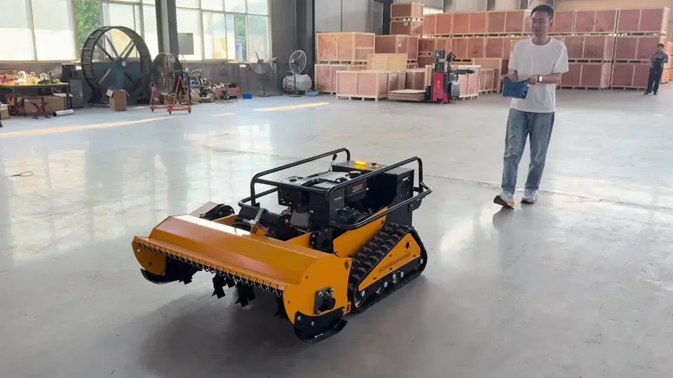An operator demonstrating a tracked mower with a remote controller